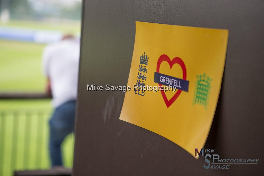 20170627-0037.jpg - Grenfell Tower poster at Lashings All Stars vs House Of Commons & Lords, 26th June 2017 Grenfell Tower Fundraising Cricket Event at Latymer Upper School Playing Fields, London.